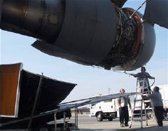 Contractors wash a C-17 Globemaster III engine with the EcoPower Engine Wash System March 12 at Charleston Air Force Base, S.C. The closed-loop system collects and recycles the runoff water, keeping potentially contaminated water off of the flightline and running off into the surrounding areas.(U.S. Air Force photo/Staff Sgt. Robert Sizelove) 