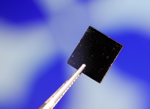 A graphene material sample that was tested for its properties is shown against an image in a test station. (Georgia Tech Photo: Gary Meek)