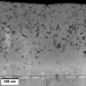 Cross-sectional transmission electron microscope image of the functionally graded smart coating with nano-silver particles distributed throughout the entire thickness of the coating. The crystalline nano-grains can be seen near the interface with the titanium implant and mostly amorphous layer on the top portion of the coating. Credit: Dr. Afsaneh Rabiei, North Carolina State University.