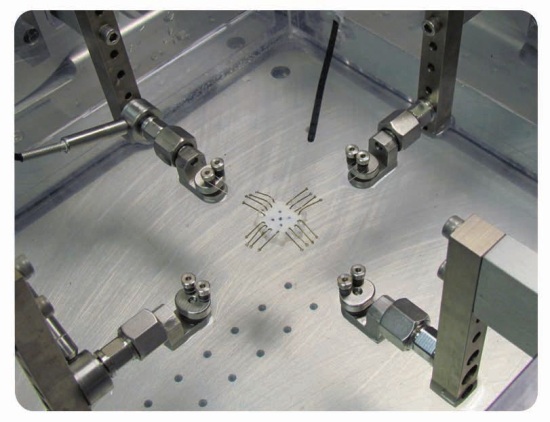ElectroForce planar biaxial TestBench instrument with hook grips in a heated saline bath