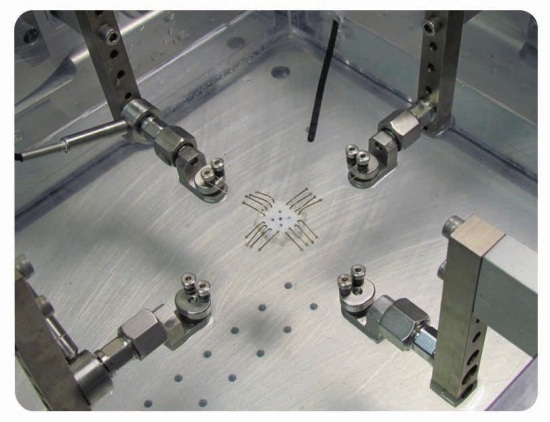 ElectroForce planar biaxial TestBench instrument with hook grips in a heated saline bath