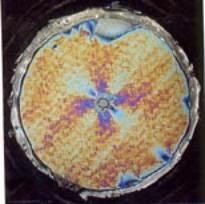 Photoelastic analysis of the strain field around a drilled hole in a novel material subjected to biaxial fatigue loading.