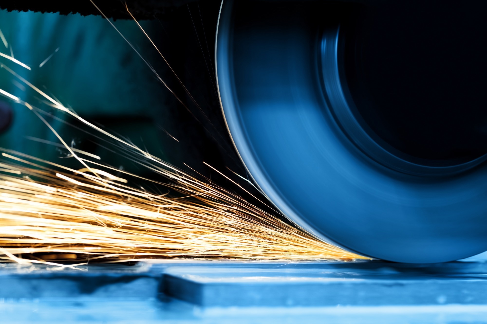 Sparks from grinding machine in workshop.