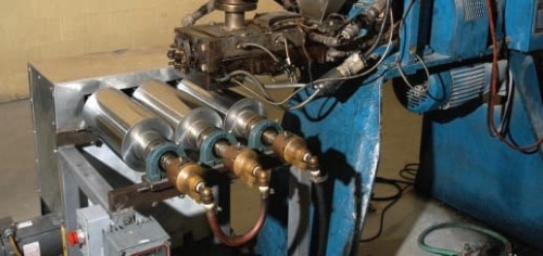 Readco Continuous Processor Barrel Extruder equipped with Three Roll Sheet Stack. Temperature controlled with Paratherm heat transfer fluid.