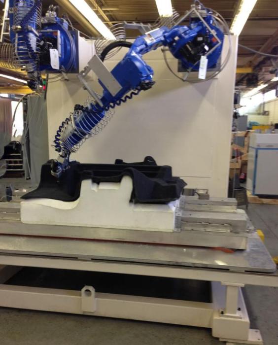 Wall-mounted robots allow for the first 2 axis to be mounted forward, over the part.