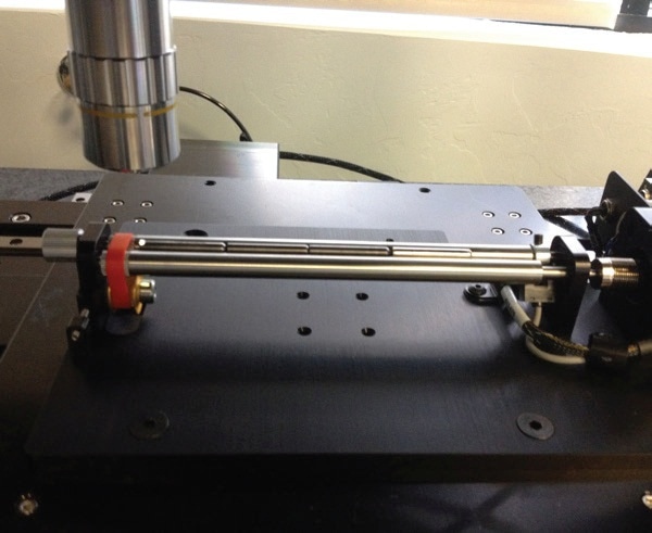 Multiple small cylindrical corrosion coupons in a multicoupon jig, ready for measurement on an NPFLEX.