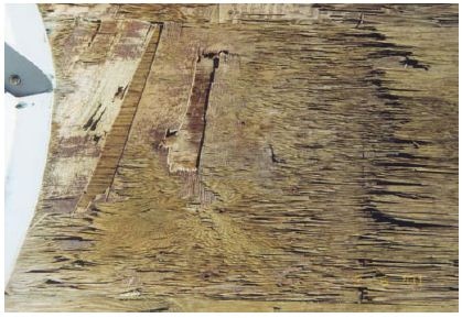 This plywood fan deck has rotted away making it dangerous for workers to walk on.