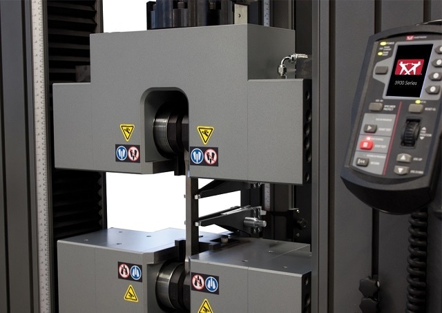 Metal specimen being tested with Durasync® side acting grips, with an AutoX750 Extensometer, capable of performing Method A1