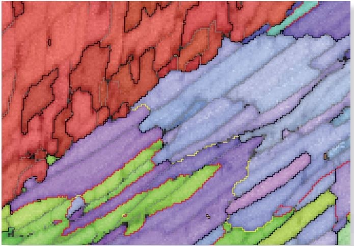 IPF orientation map, showing high angle boundaries in black and low angle boundaries in grey. In aragonite, special boundaries are marked in red (63.8° <001/>) and yellow (52.4° <001>).