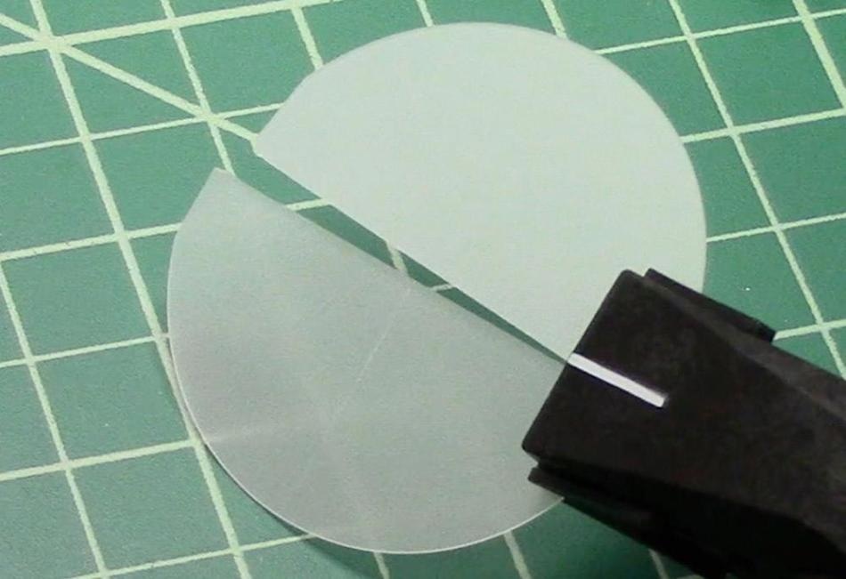 Bare sapphire wafer during cleaving with Cleanbreak Pliers.