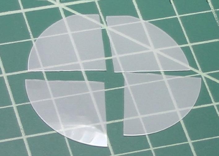 Bare sapphire wafer after cleaving into quarters using the FlipScribe and Cleanbreak Pliers.