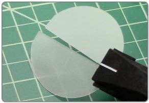Bare sapphire wafer during cleaving with Cleanbreak Pliers.