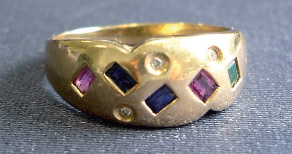 Gold ring with diamonds and green emerald.