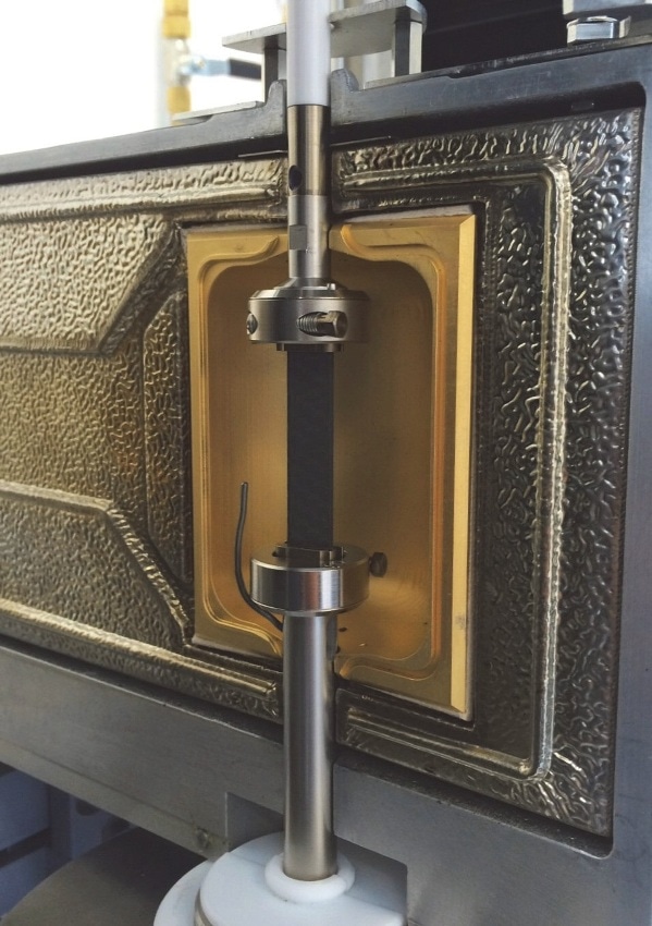 Solids clamping tool with carbon fiber enforced composite sample.