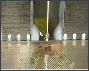 Diamond wedge indenter close to the sample surface.
