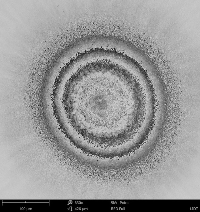 BSD SEM image of laser-induced damage on an optical coating.