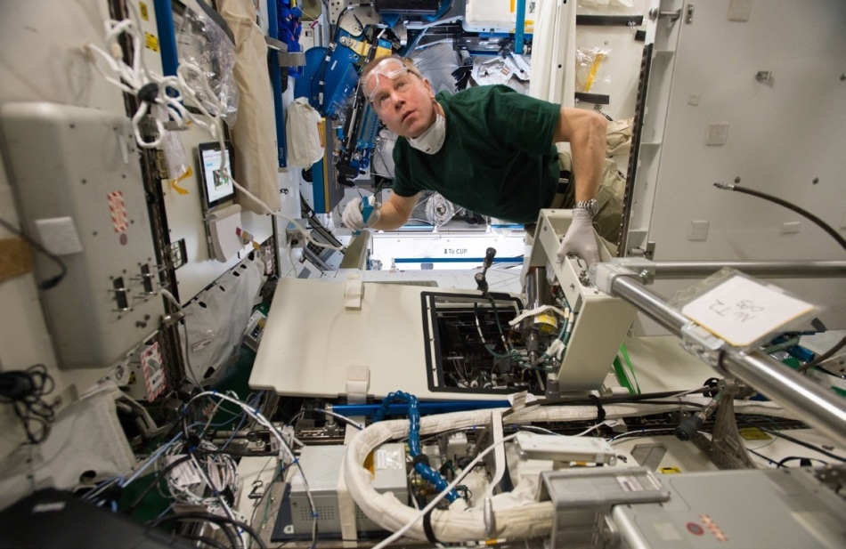Astronaut Tim Kopra carrying out routine maintenance on the urine processor assembly. Photo: flickr.com/photos/ nasa2explore.