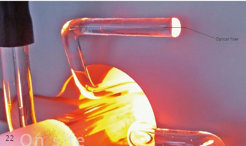 Close-up of part of the Combustion Module's sample injection system. Light from the pyrolysis oven is conveyed through the optical fiber to the flame sensor. To make it easier to see the optical fiber, the flame sensor has been removed from this image.