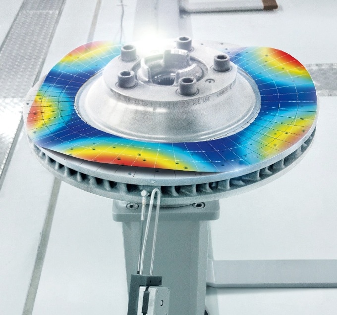 A PSV-3D Xtra Scanning Vibrometer measuring a break disk, excited by the SAM Scalable Automated Modal Hammer.