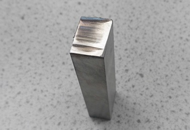 Tarnishing of a titanium sample due to incorrect selection of the cutting disc and insufficient cooling during the cutting process.