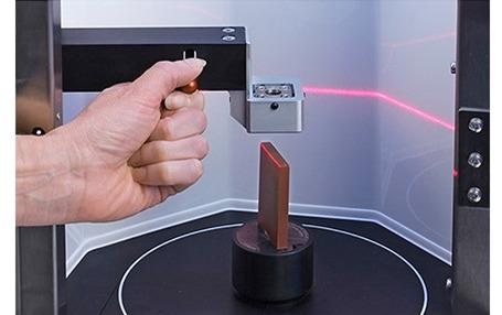 A laser scans the sample whilst it rotates to produce a 3D scan.