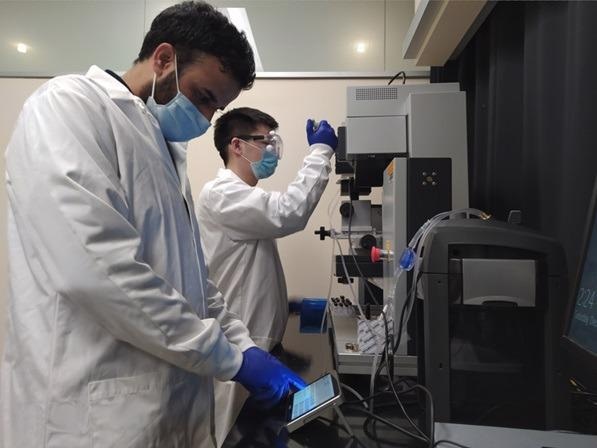 Adil and Yang, members of Prof. Wang’s group at OSU, working with the Linkam temperature control setup in the lab.