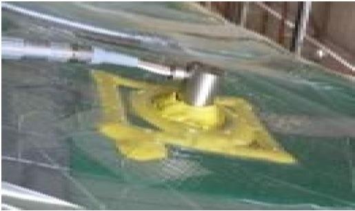 Layup for cure monitoring with a DC sensor and vacuum bag.