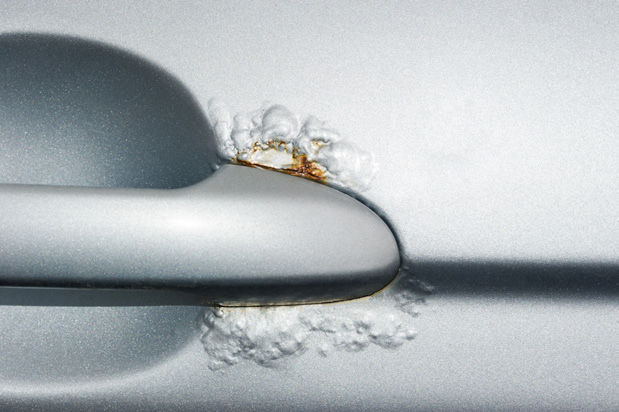 Defective coating on car door.