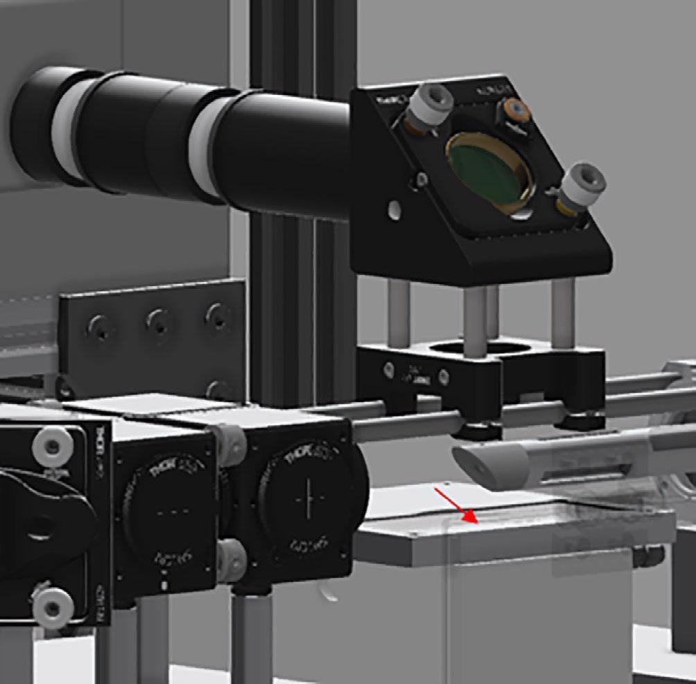 CAD image of the instrument—sample interface. Red arrow indicated sample position.