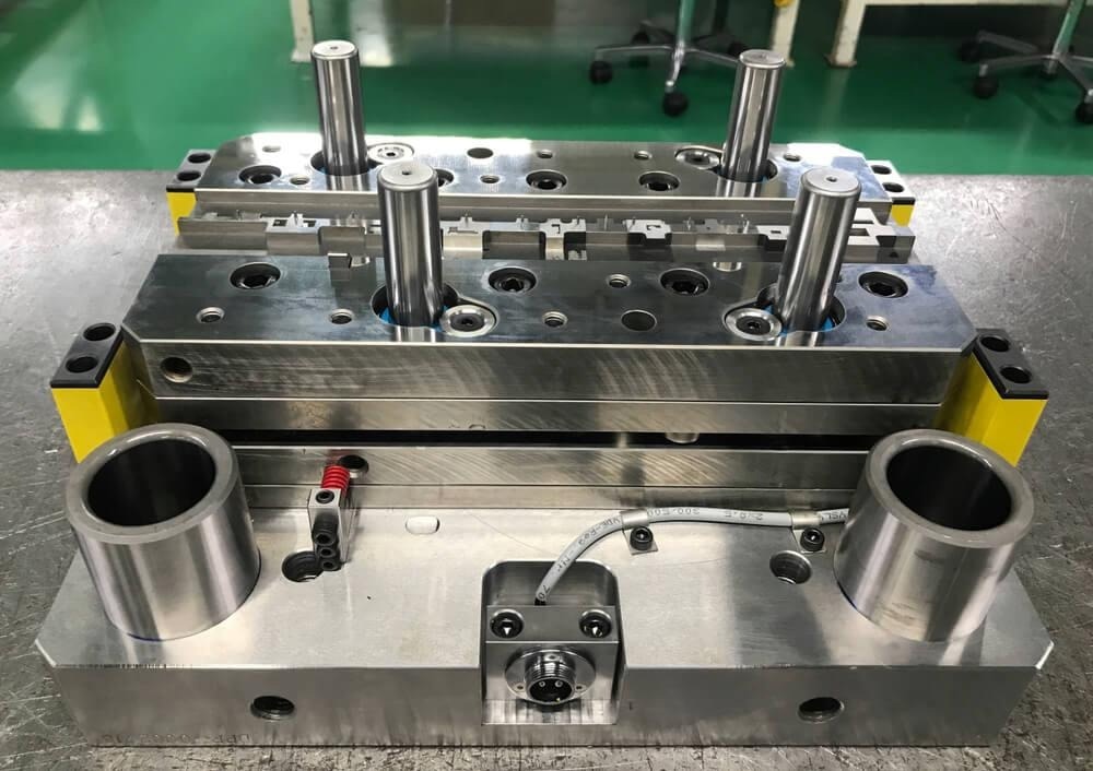 A progressive stamping die on the repair table.