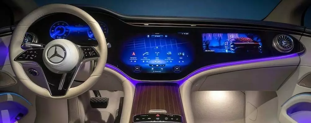 Mercedes-Benz 2022 EQS 56” “Hyperscreen” includes an LCD instrument cluster display and two flexible OLED screens for center-stack and passenger displays, with all panels bonded under a single sheet of cover glass.