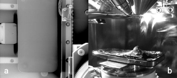 iPhone in the VEGA SEM chamber. (a) Wide-field SEM image of an entire iPhone 4S. This is a single image with a field-of-view (FOV) of 128mm. The wide-field scan mode is unique in providing very large field-of-view image with little distortion. (b) Chamberview image of the iPhone 4s on the VEGA SEM stage, after a single shot from a .22 caliber revolver. The exit cone that was created by the round is facing upward, toward the microscope’s objective lens. The bullet struck the front side of the phone, in the upper area of the display and it did not fully penetrate the backside of the case.