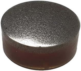Polished resin block containing ore particles.