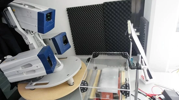 Example of thermal characterization setup: display exposed to high temperatures inside the climatic chamber. Laser vibrometry measurement performed through the plexiglass wall.