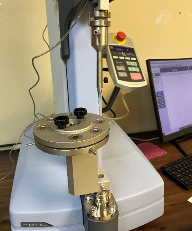 Test setup on the EZ-LX showing the lower support and needle holder with hypodermic needle attached