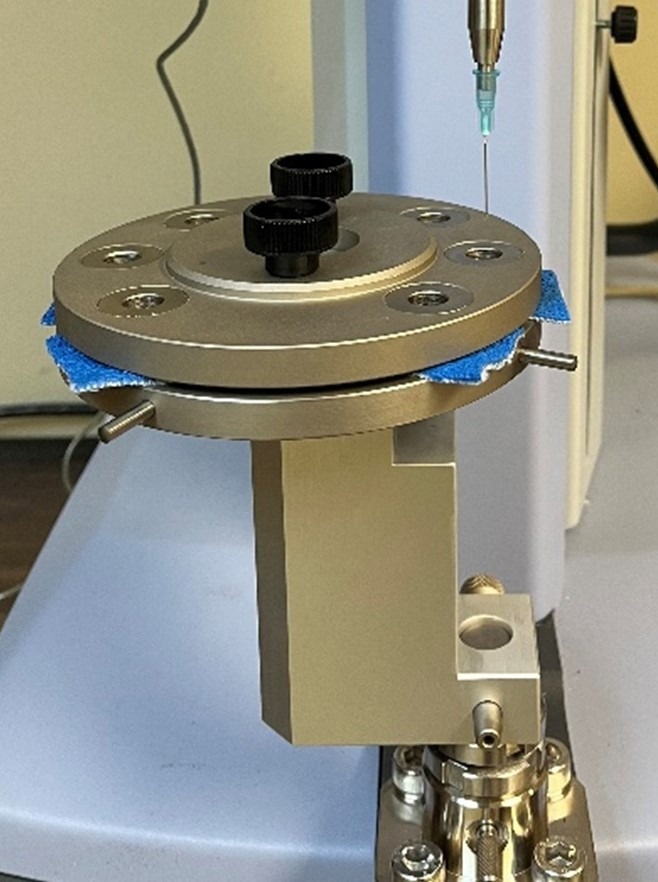 Samples (from Glove A in the photo) are fully loaded and are being tested with the hypodermic needle 20 mm above the sample