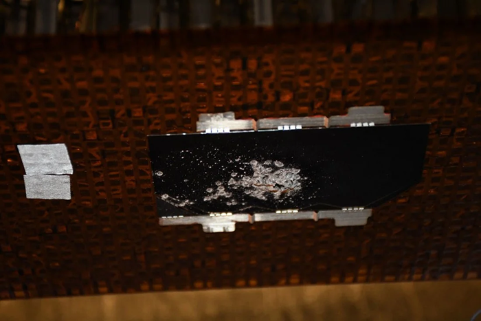 Perforated photovoltaic cell through a dense particle cloud