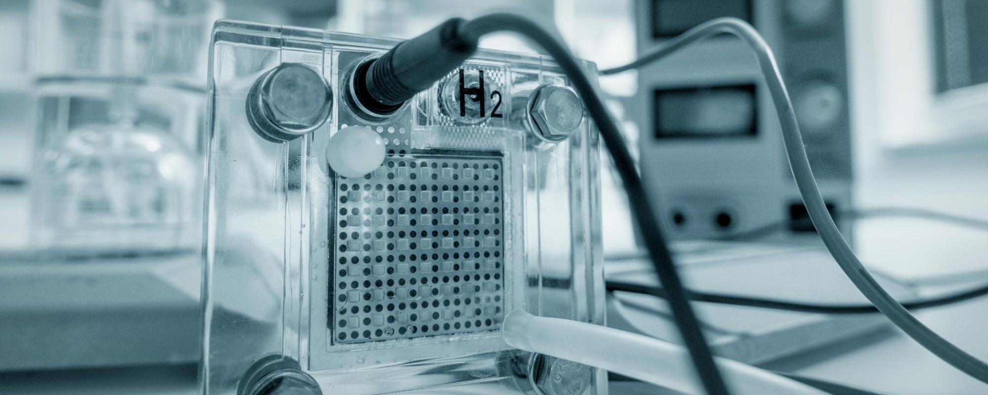 Close-up of a proton-exchange membrane fuel cell with hydrogen input, used in energy storage and proton battery technology for sustainable energy conversion