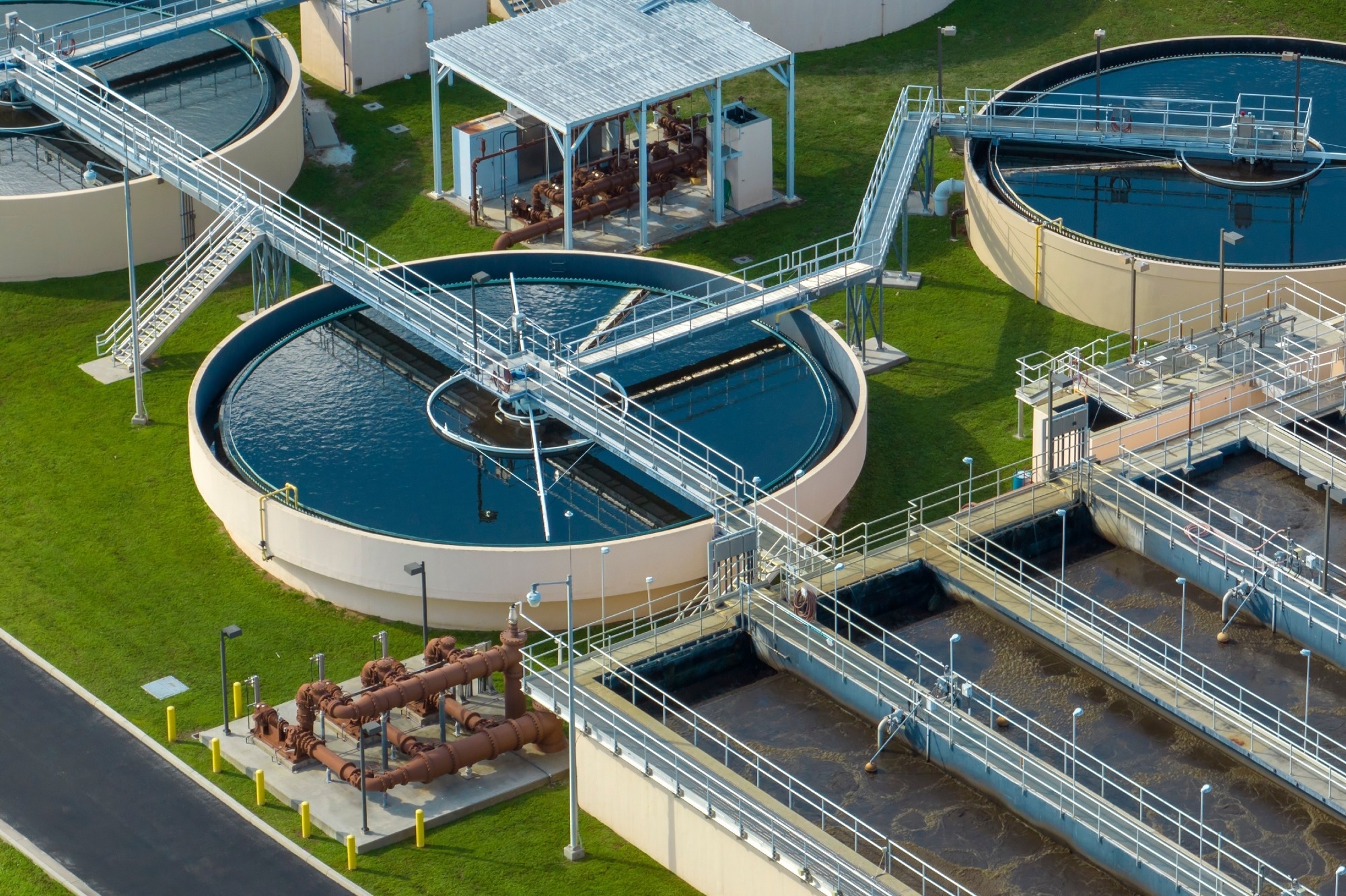 Aerial view of modern water cleaning facility at urban wastewater treatment plant. Purification process of removing undesirable chemicals, suspended solids and gases from contaminated liquid.