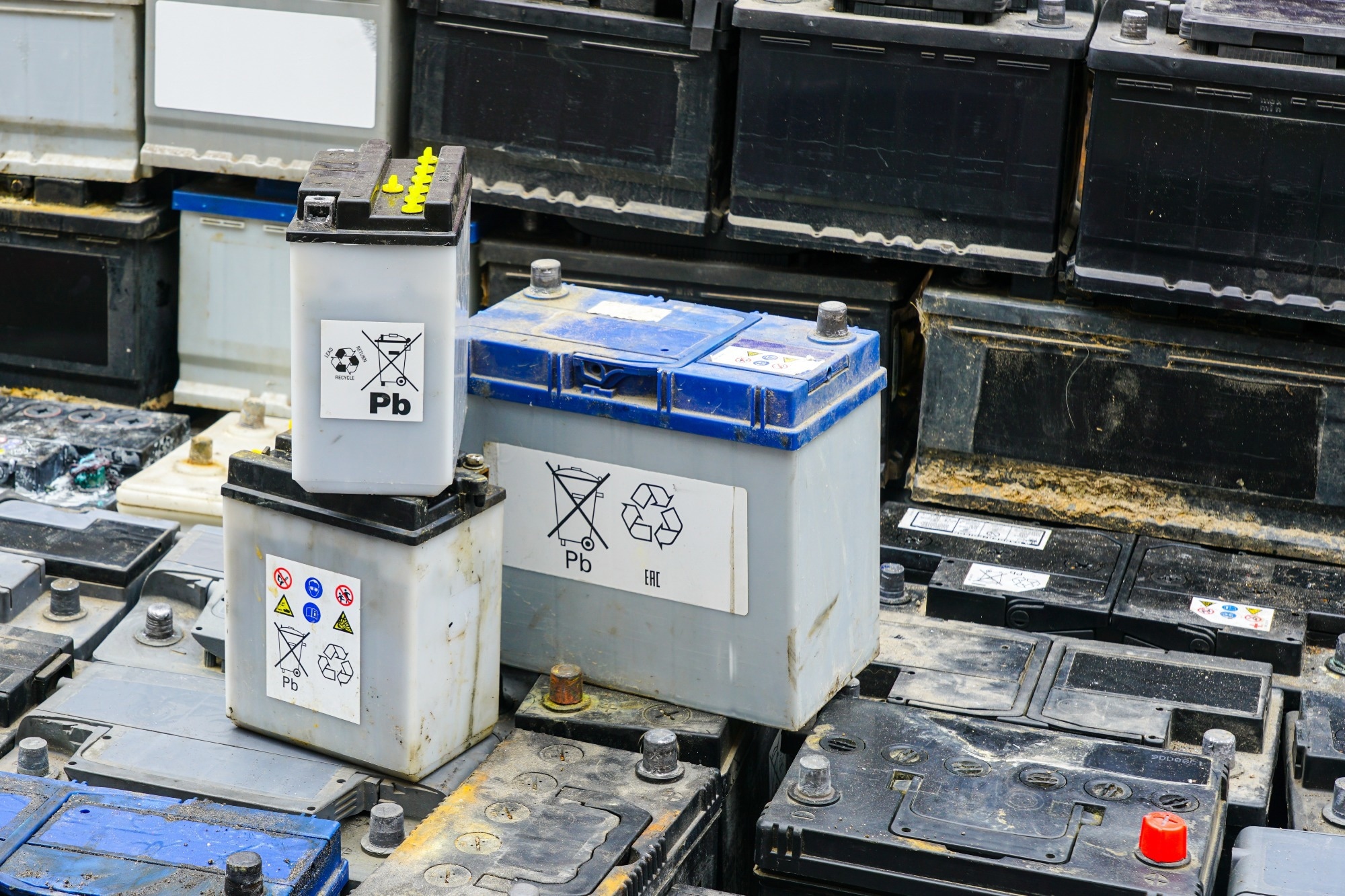 A pile of used car batteries (presumed to be) lithium ion.