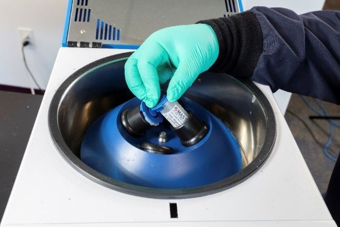 Centrifuging three samples.