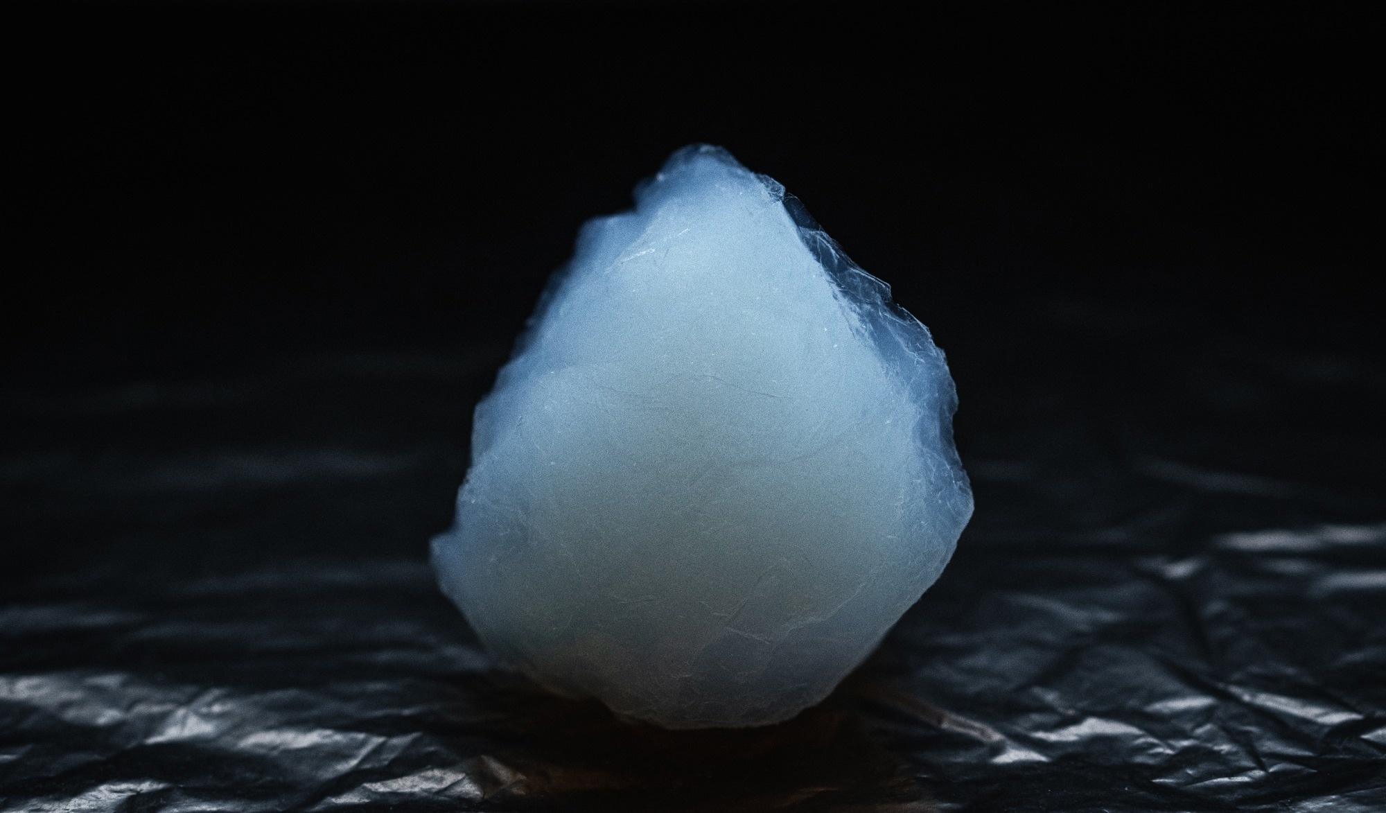 Upclose photo of aerogel material, translucent white blob.