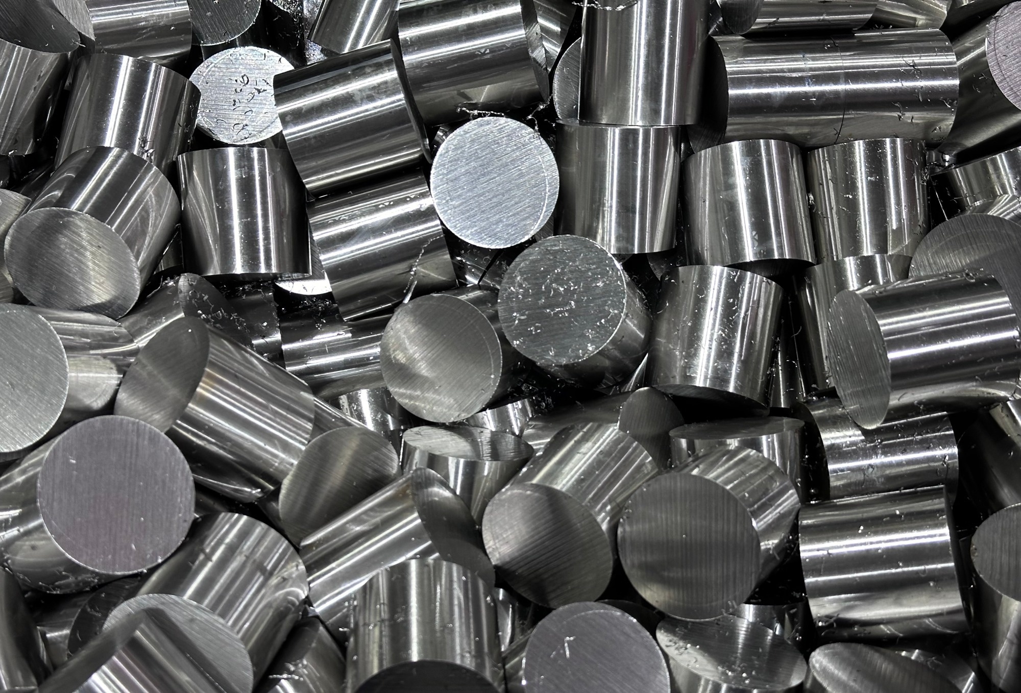 A stack of alloy metal tubes cover the entire picture. They are short cylinders of metal.