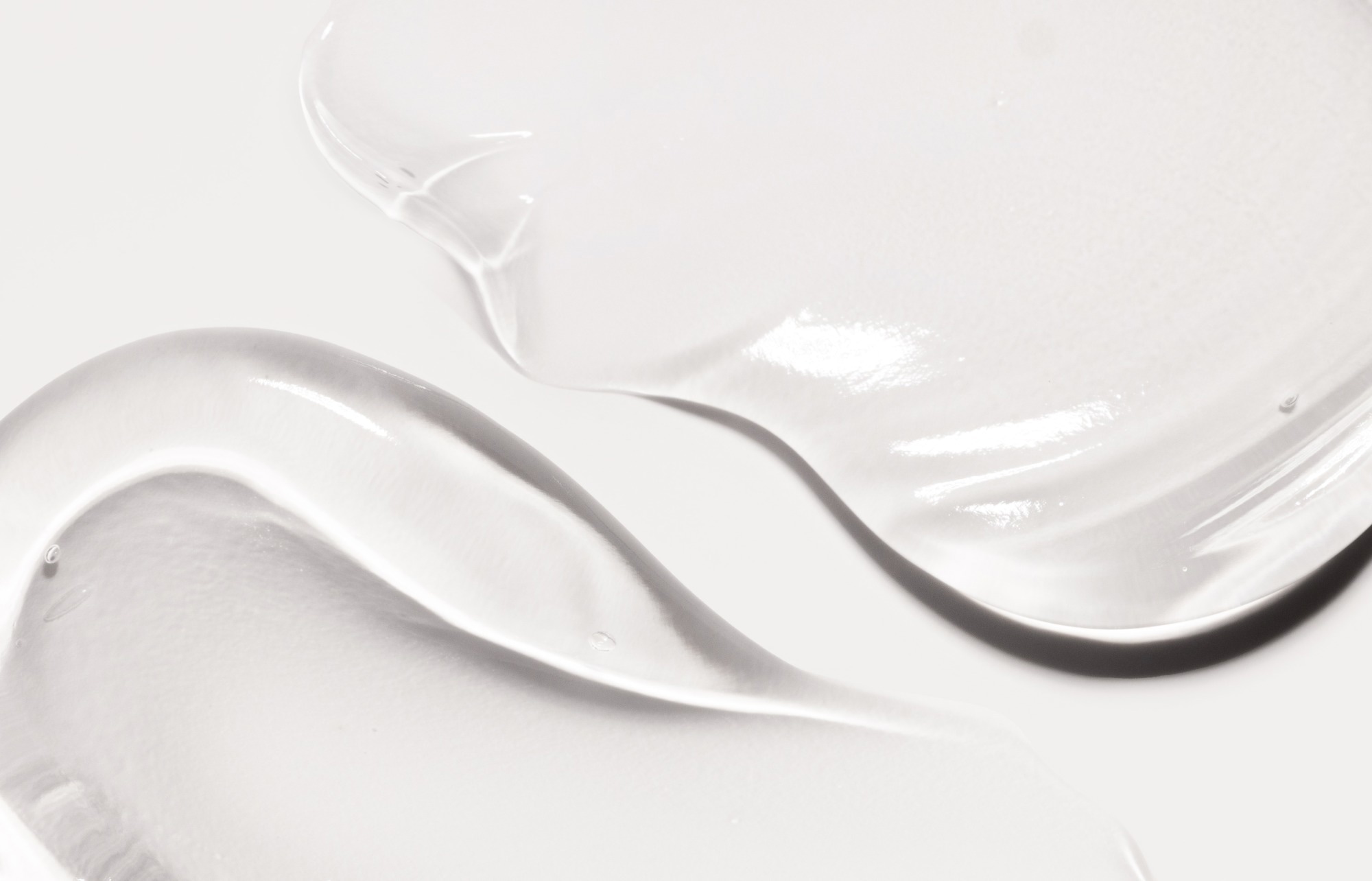 Clear gel smeared against a white background.