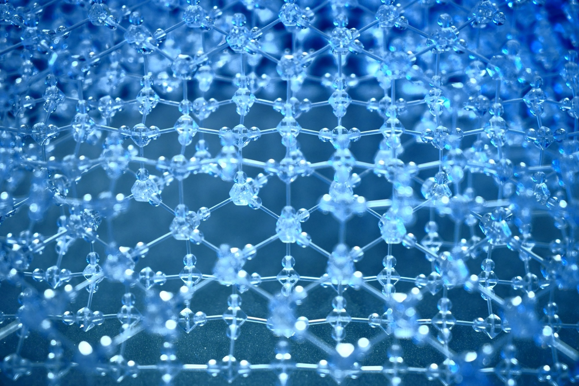 An image of the atomic structure of a snowflake. This is a stylistic choice, the image is meant to represent an intricate polymer network.