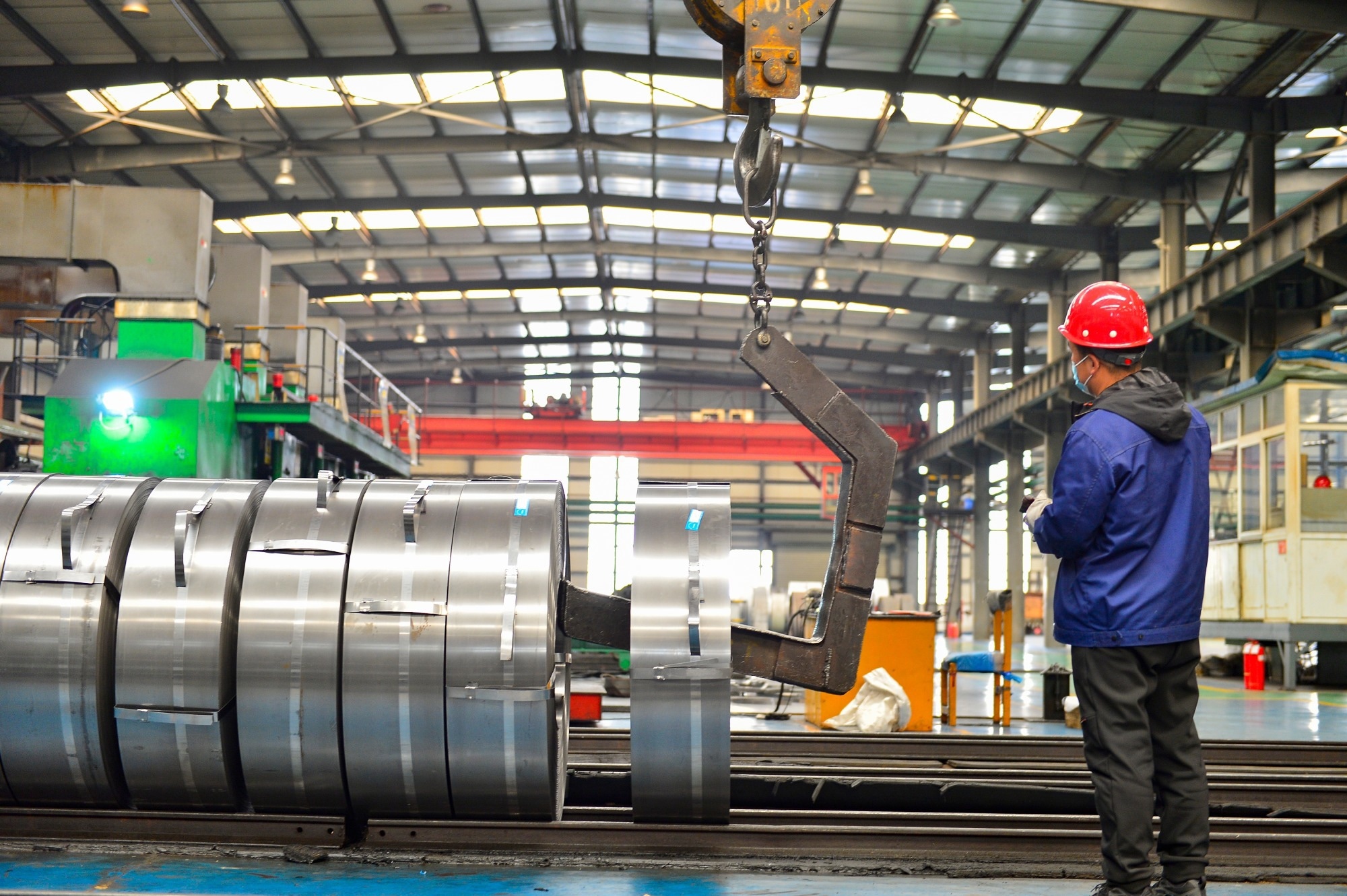 Workers in hot-rolled strip steel mills produce