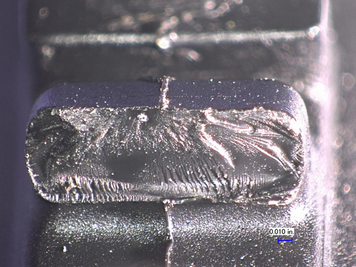 The fracture surface is shown with crack initiation at an inclusion