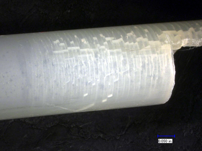 Broken tubing, showing a series of parallel transverse cracks with brittle fracture features