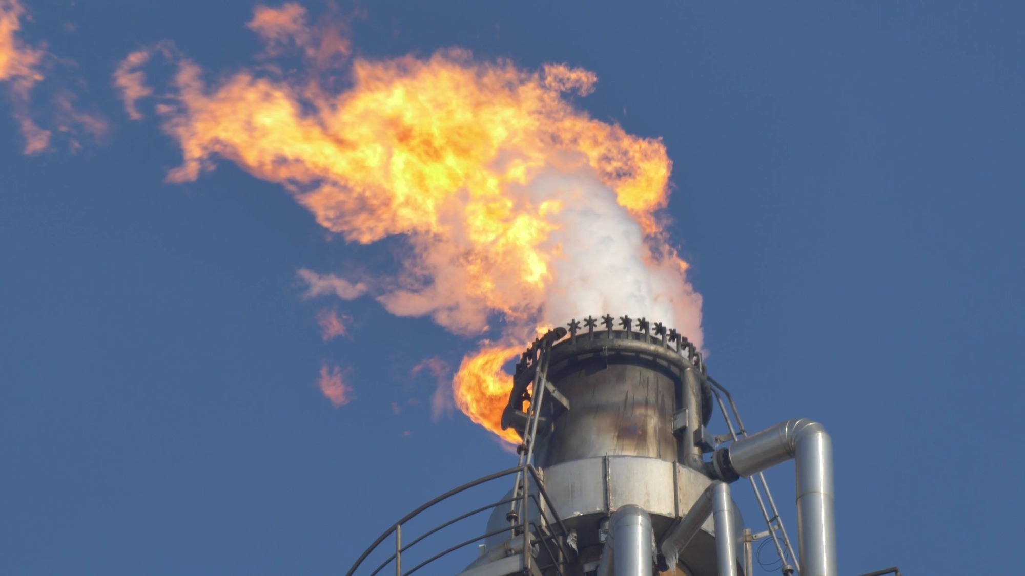 Fire Burning on Top of Gas Flare Stack Chimney in Petroleum Refinery Slow Motion