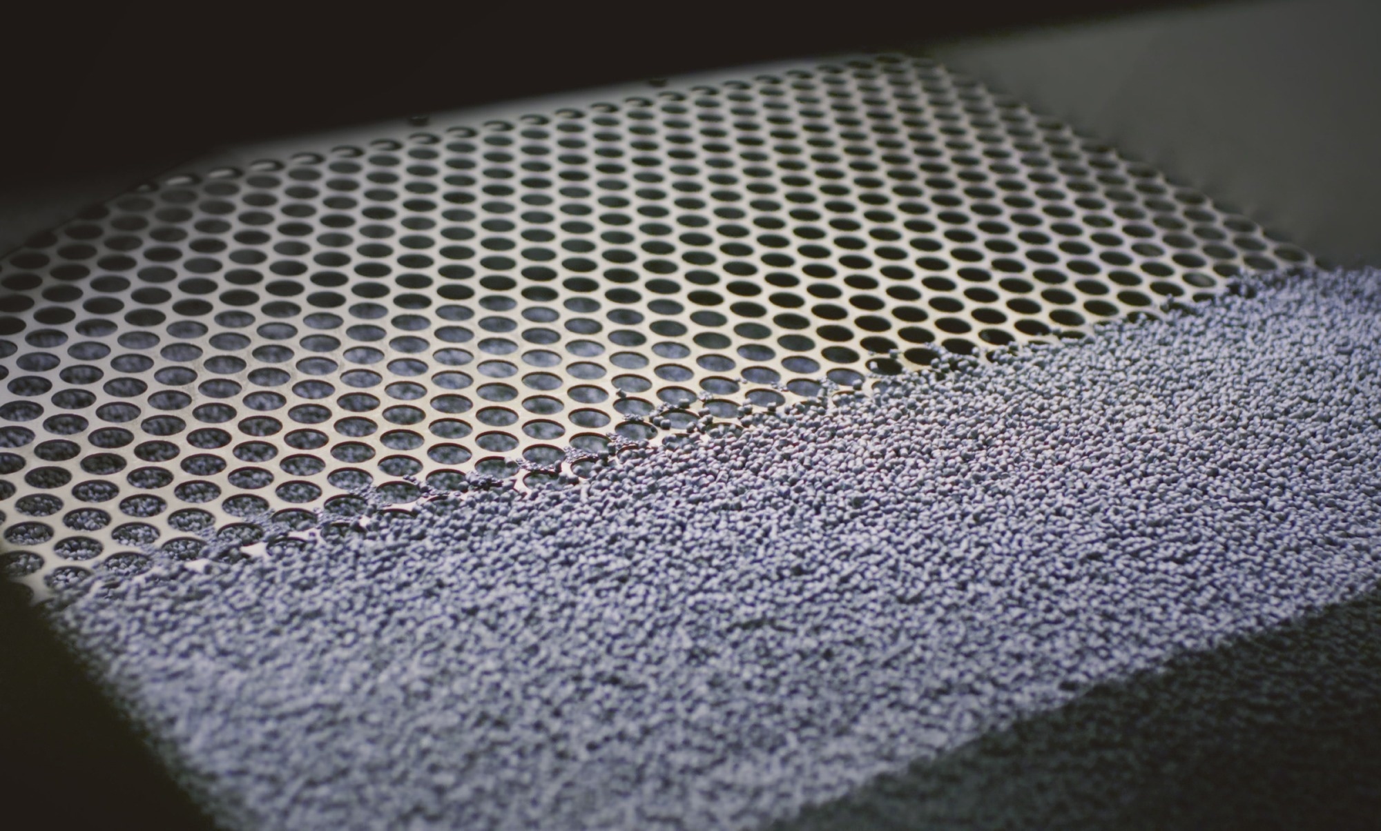 Extruder machine makes plastic granules, recycling polypropylene. Gray plastic pellets.